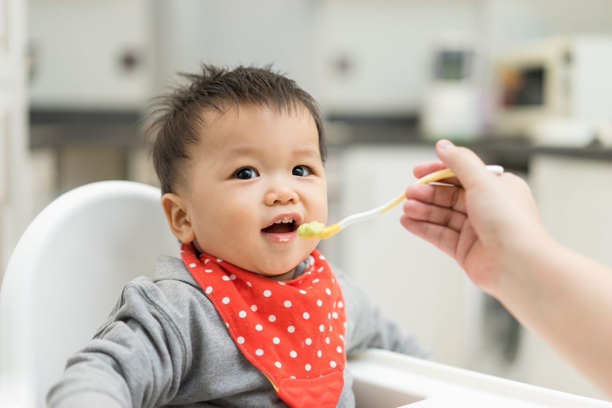 Asian baby eating a breakfast Photograph by Anek Suwannaphoom