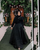 6. Anggun long dress hitam beraksen ruffle dada