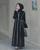 4. Pilih gamis berhiaskan motif kecil atau garis-garis vertikal