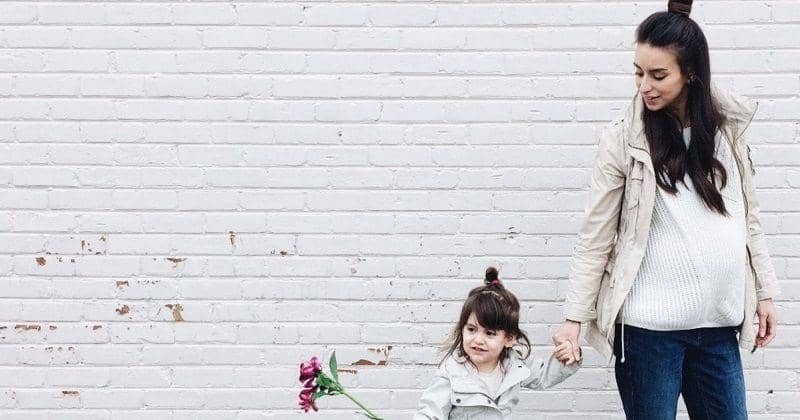 Pregnant mom with her daughter - Motherly