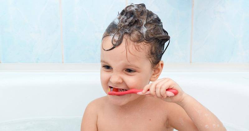 Anak menggosok gigi ketika mandi. - Freepik/User18526052