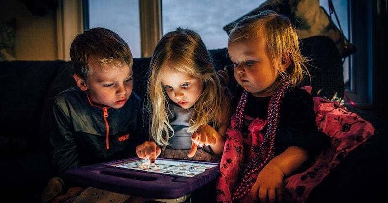 Pexels/https://www.pexels.com/photo/three-children-looking-at-a-tablet-computer-3536480/