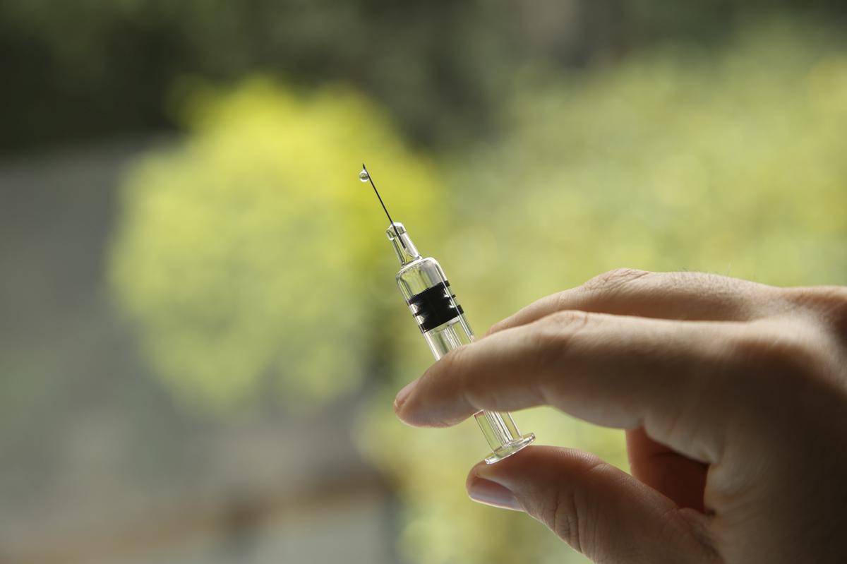 closeup-shot-female-holding-syringe.jpg