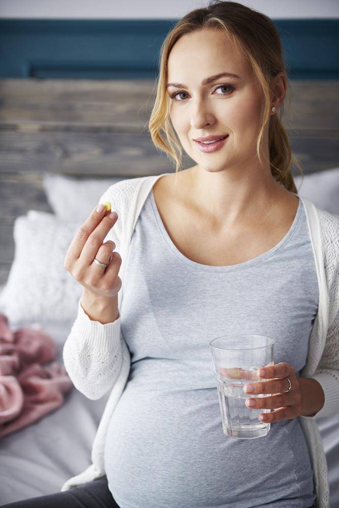 portrait-young-pregnant-woman-taking-medicine.jpg