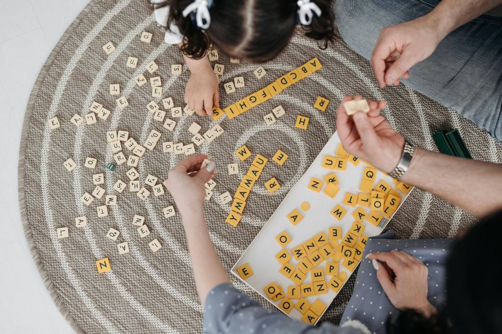 Orangtua dan anak bermain scrabble
