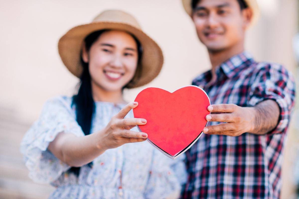 happy-young-couple-is-holding-red-paper-hearts.jpg