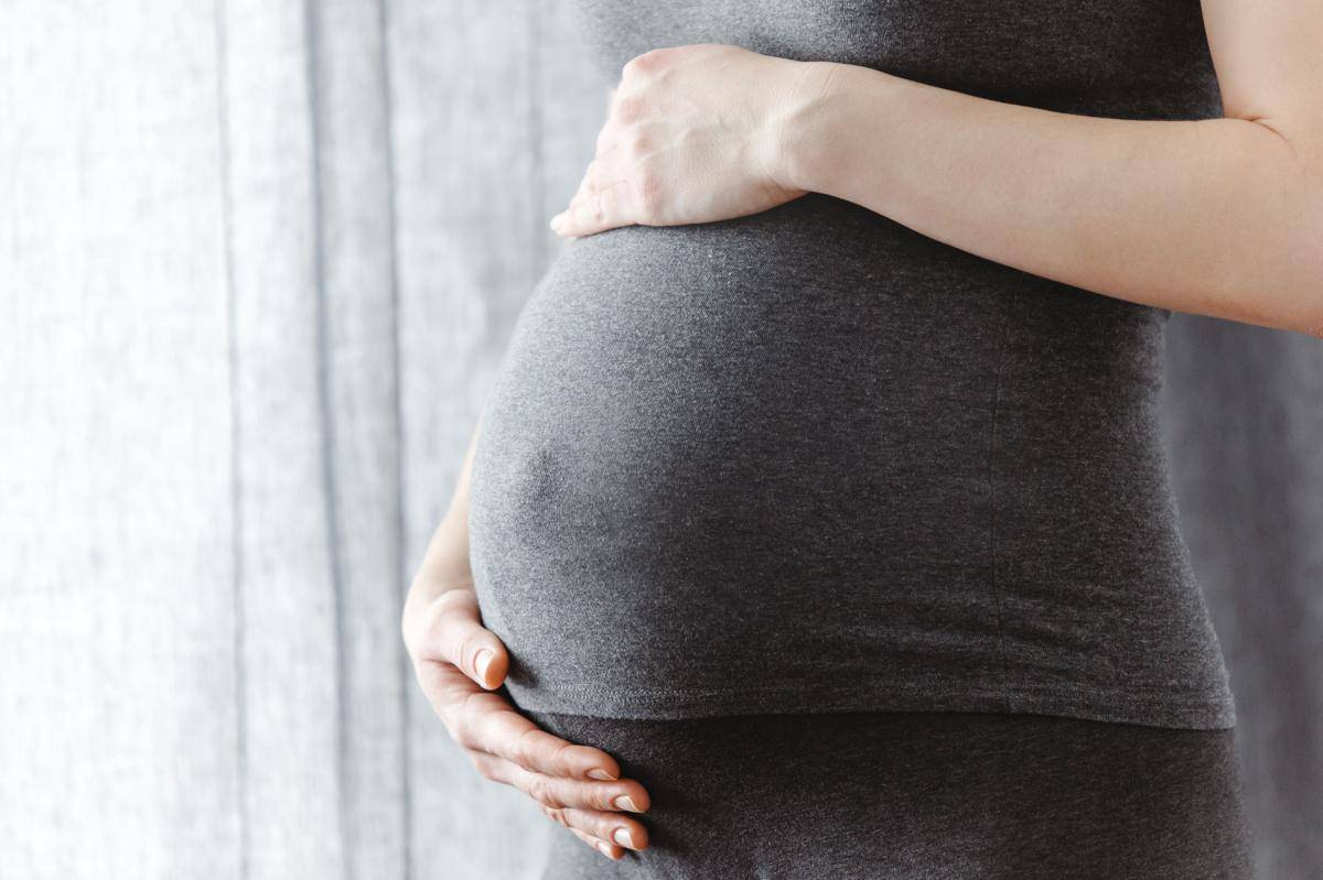 young-pregnant-woman-touching-her-belly.jpg