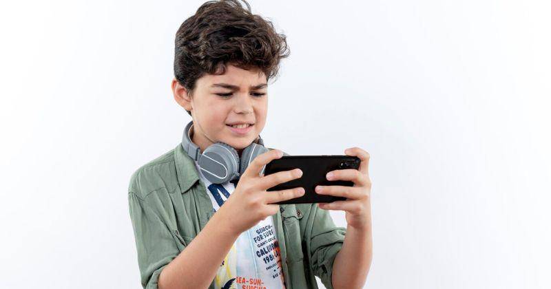 little boy playing with gadget