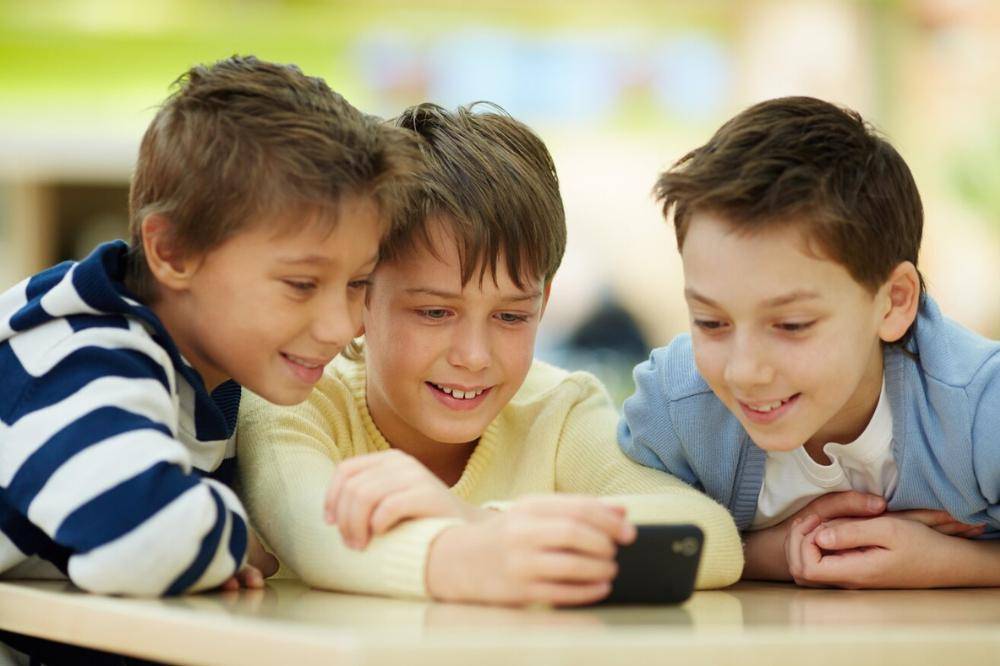 Kelompok anak laki-laki melihat smartphone