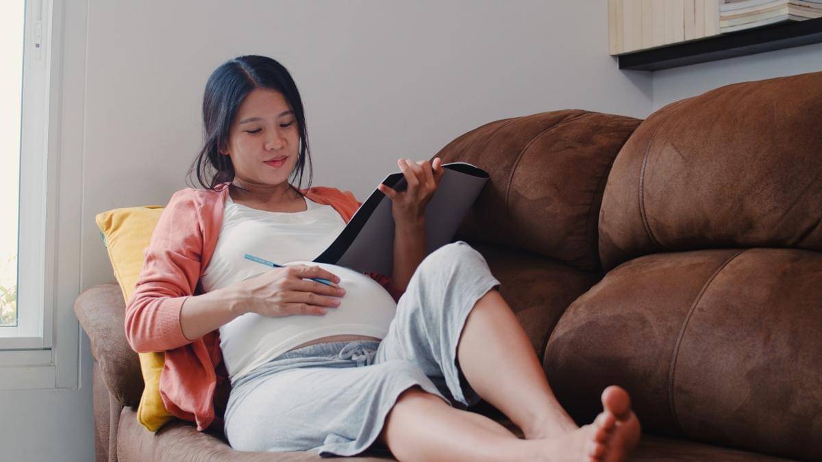 young-asian-pregnant-woman-drawing-baby-belly-notebook-mom-feeling-happy-smiling-positive-peaceful-while-take-care-child-lying-sofa-living-room-home.jpg