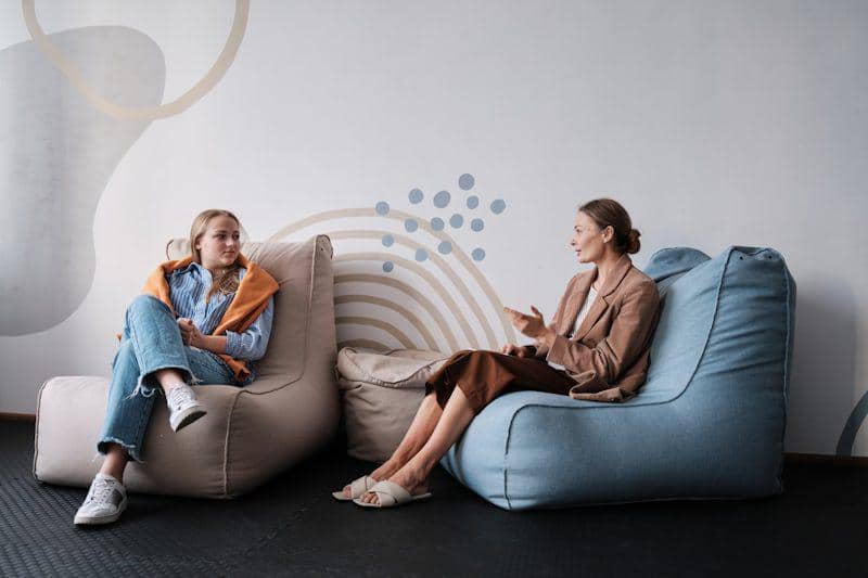 https://unsplash.com/photos/two-women-sitting-on-bean-bags-in-a-room-E-iHRaaKKc8