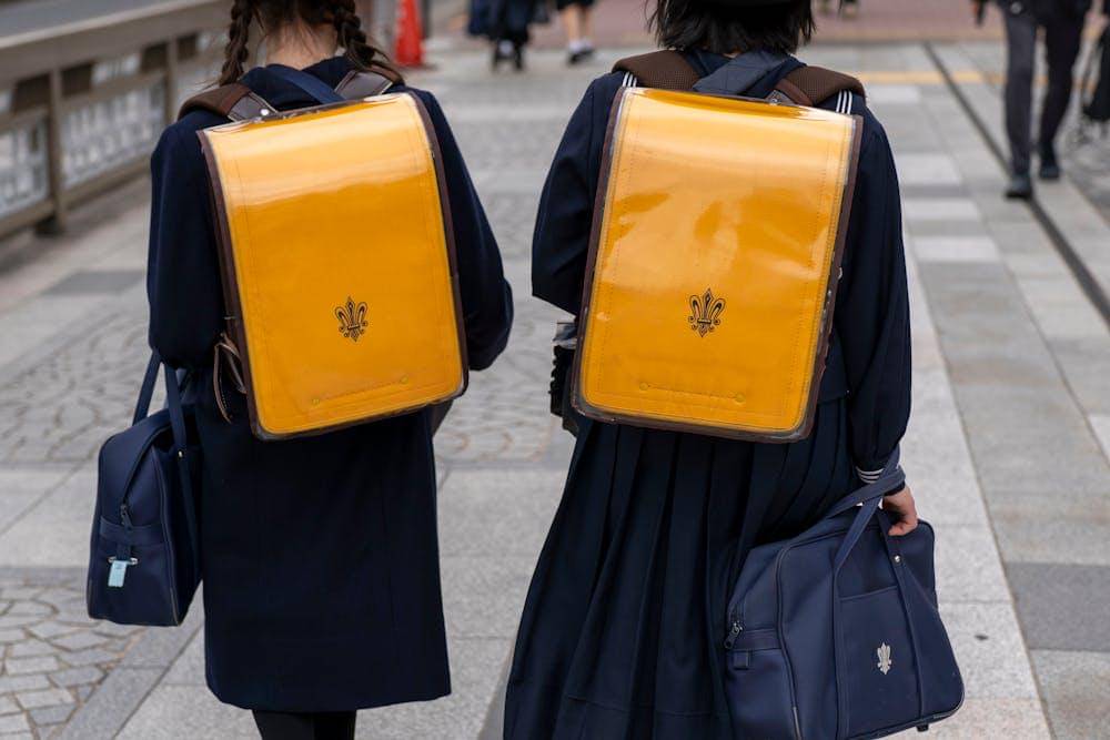 japanese schoolchildren walking in uniforms