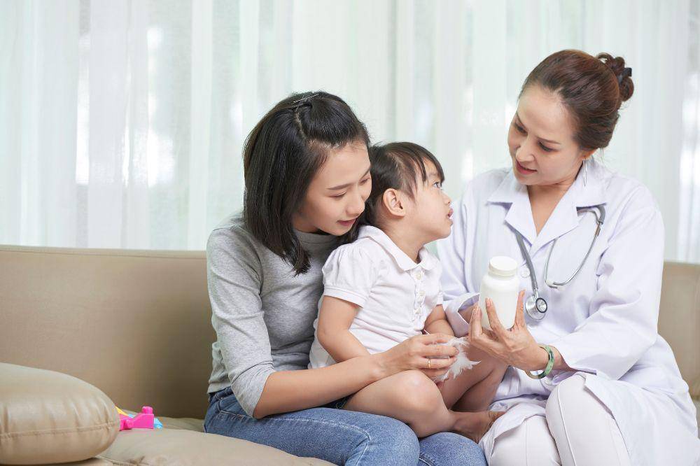 Mother and daughter visiting pediatrician
