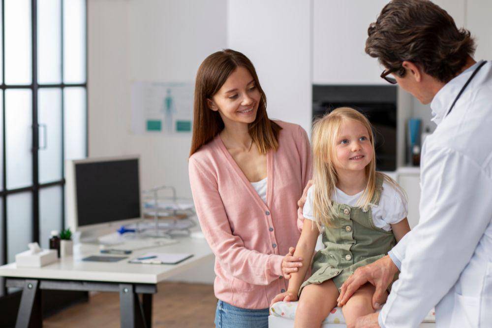 Young girl with her mother at the doctors office