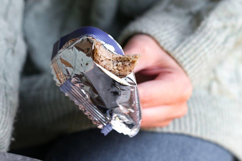 a person holding silver food wrapper