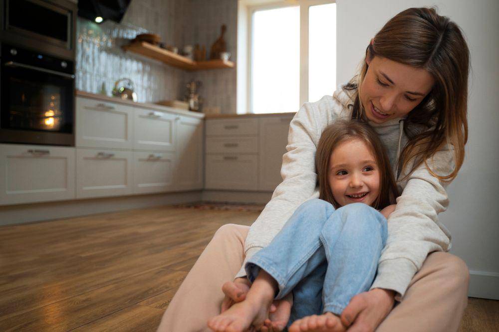 Young mother making her daughter laugh