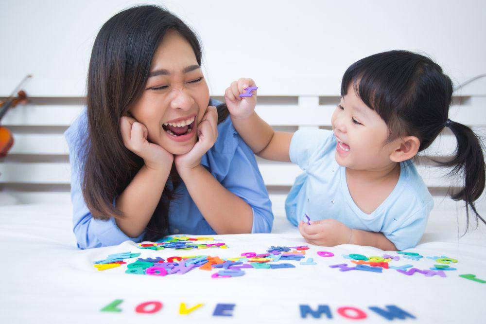 Mother and daughter studying the alphabet