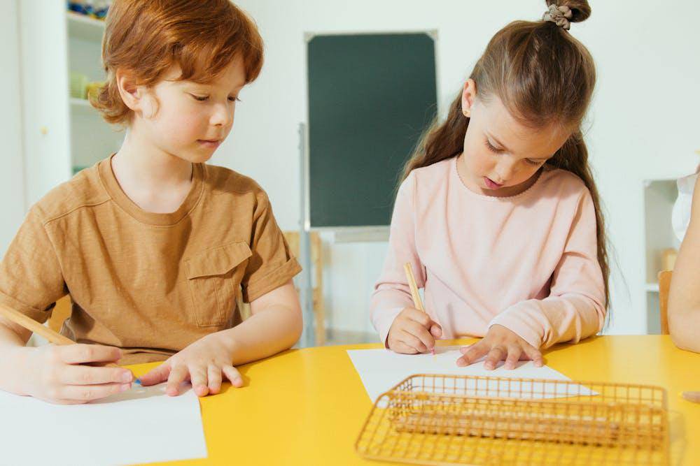 elementary students writing on a paper
