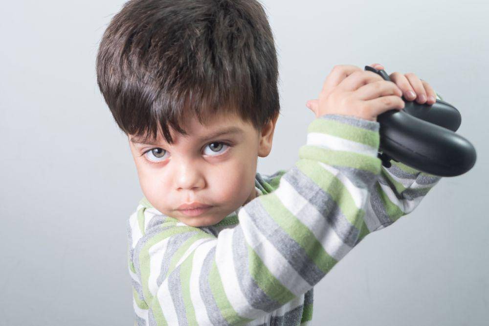 Baby boy gamer with controller in hand
