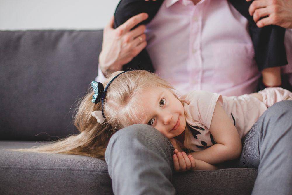 Girl lying on her father's legs