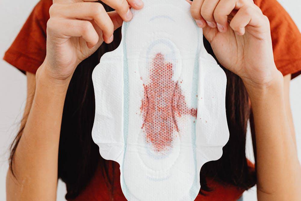 woman holding a sanitary napkin