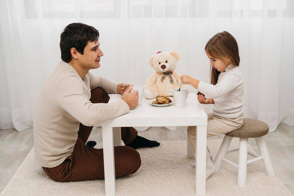 Father playing with his daughter at home