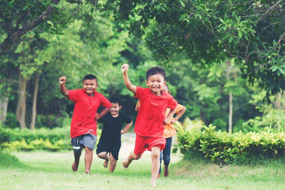 Group of young children running