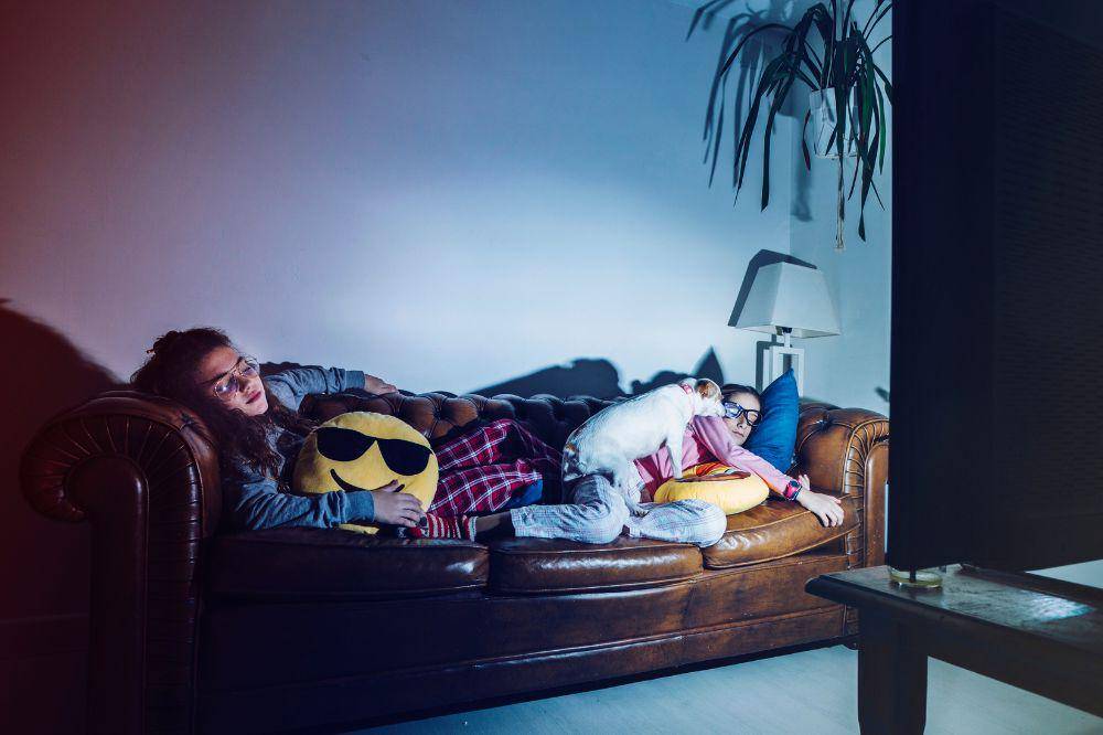 Tired girls sleeping with tv on