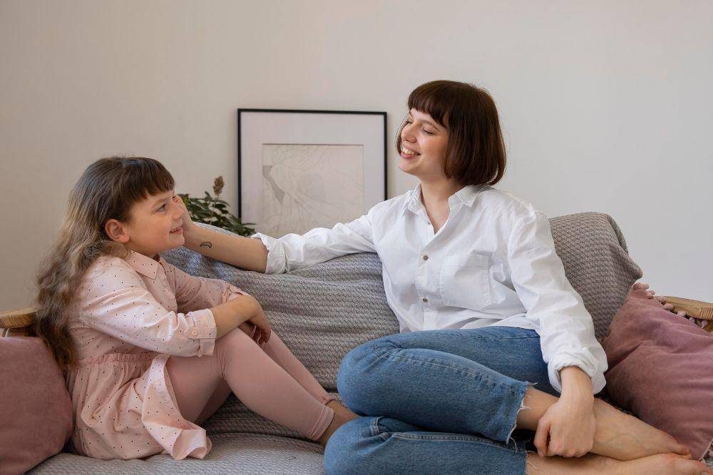 Full shot woman and kid in living room