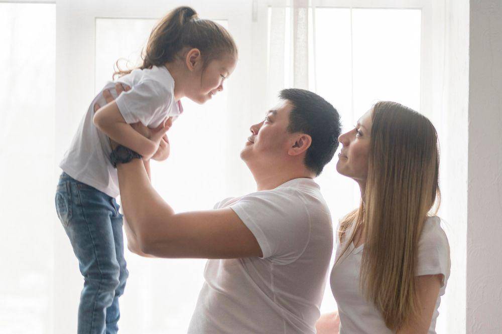 Parents playing with daughter