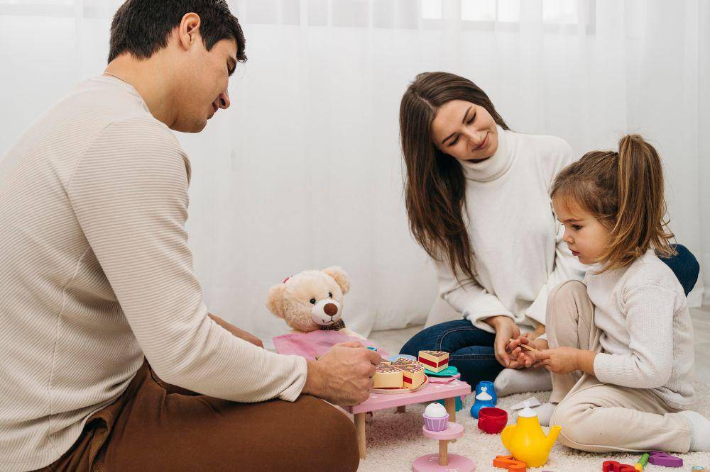 Daughter playing with parents at home