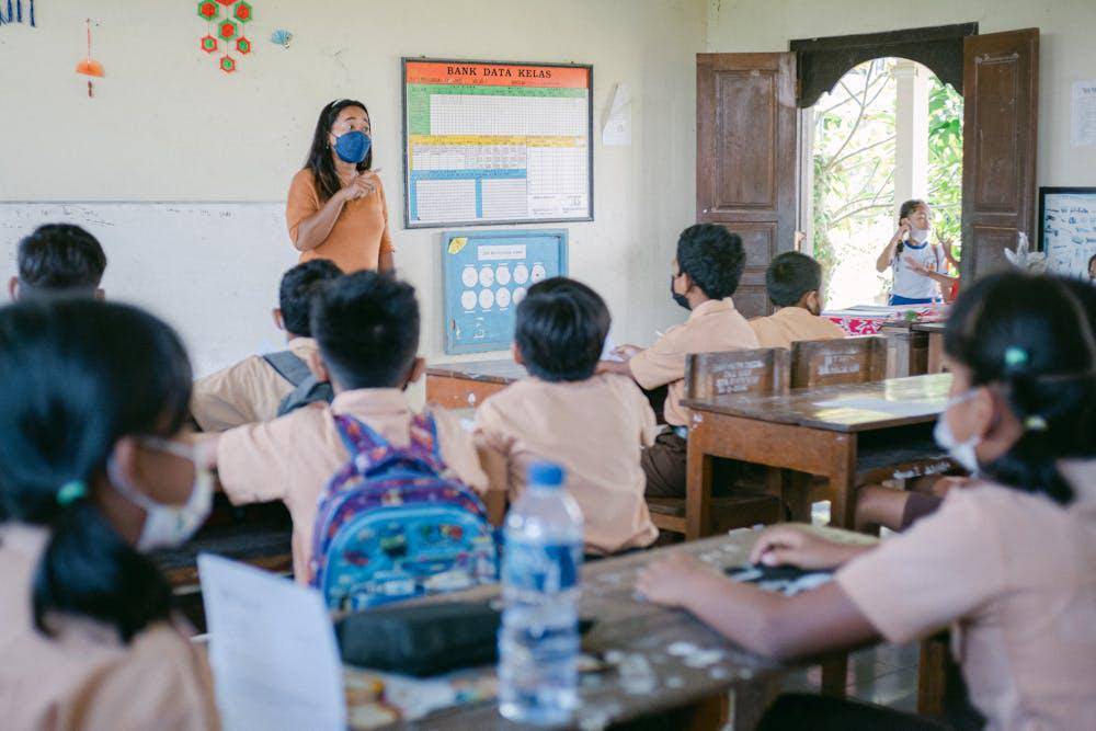 woman teaching children in a classroom