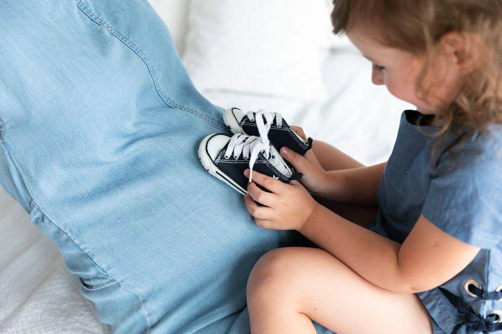 little girl playing with smalls shoes