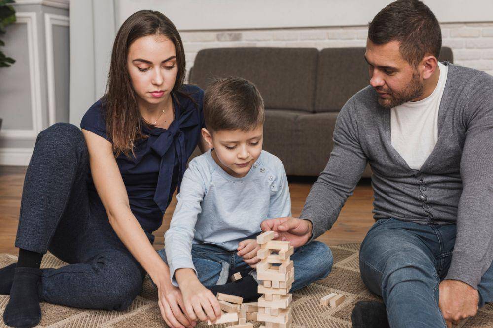 family playing jenga together