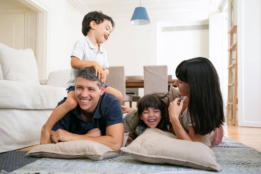 Happy laughing parents and two little kids
