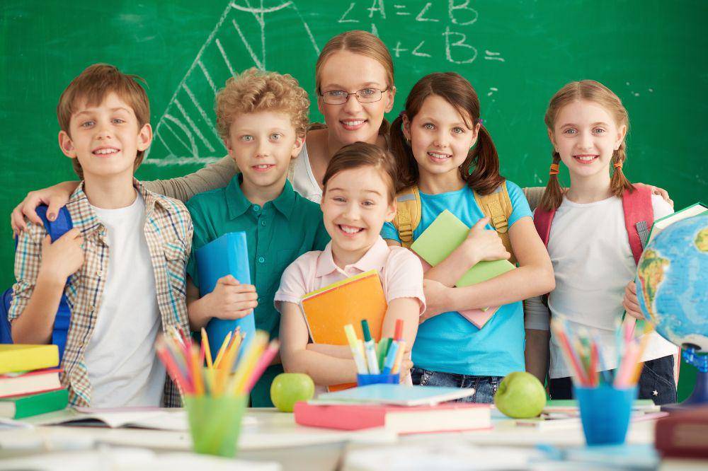 Proud teacher with her elementary students