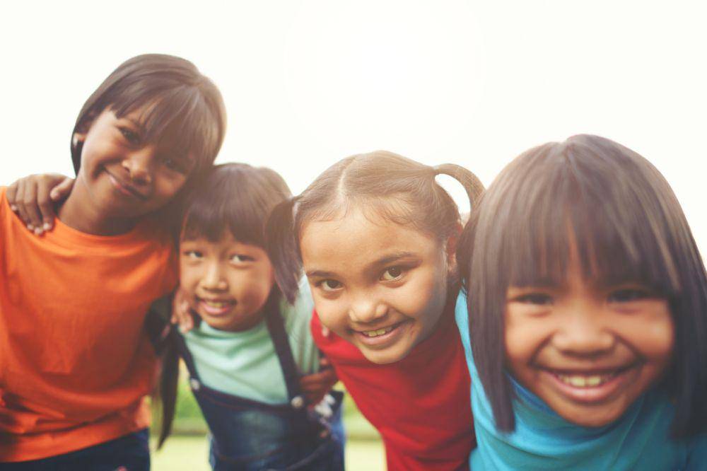 girl child friends in a park smiling