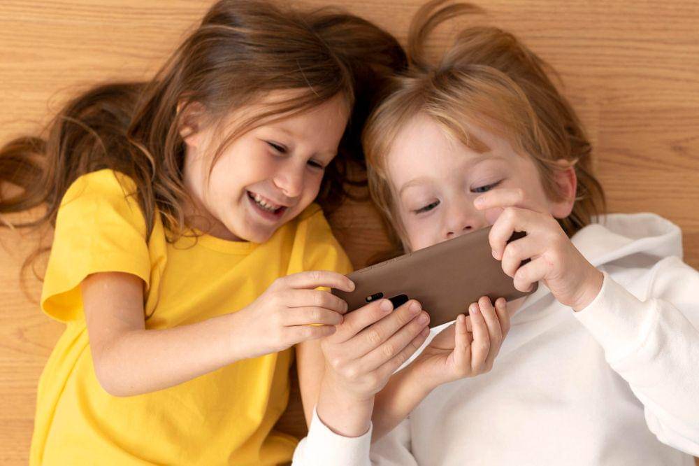 young kids using smartphone together