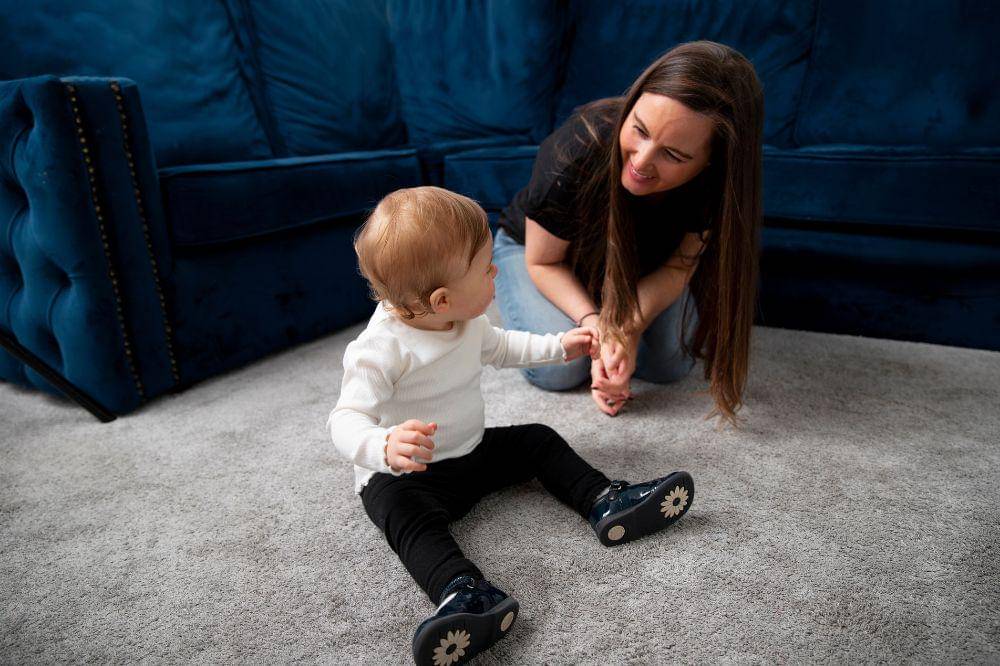 smiley woman and kid indoors