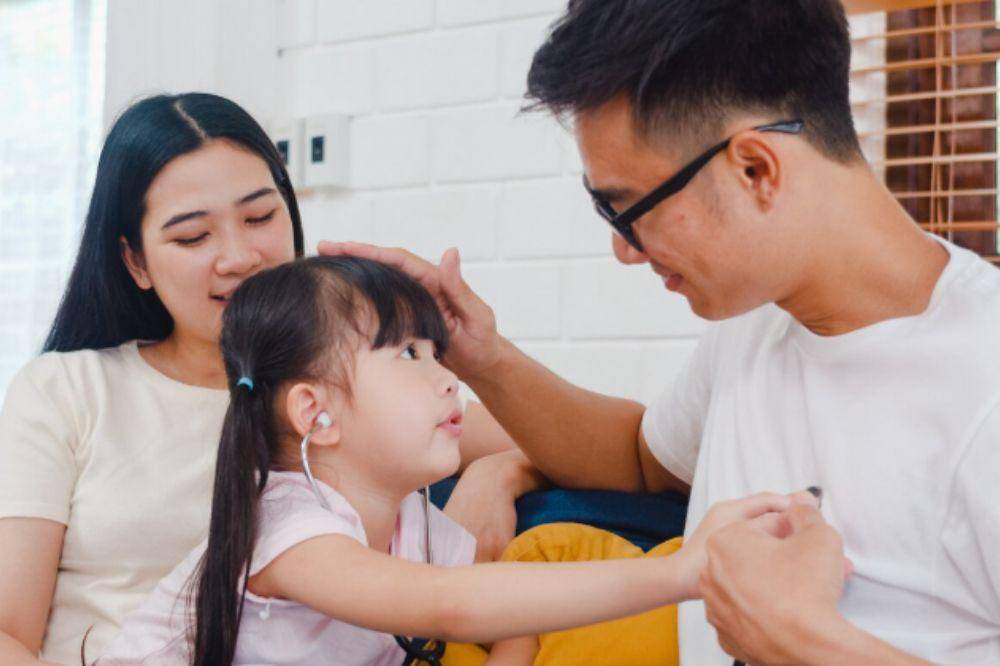 parents playing with their daughter