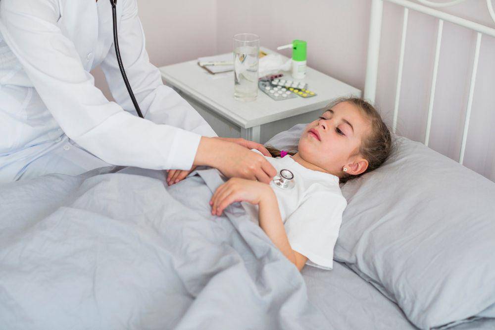 Ill girl being examined by the doctor