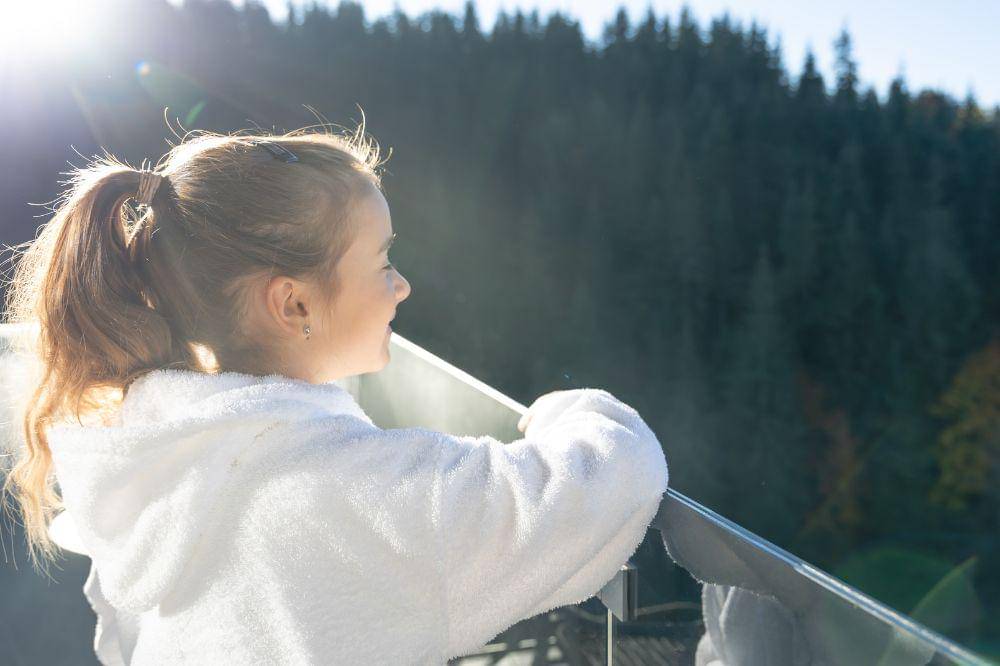 girl in a bathrobe on the balcony