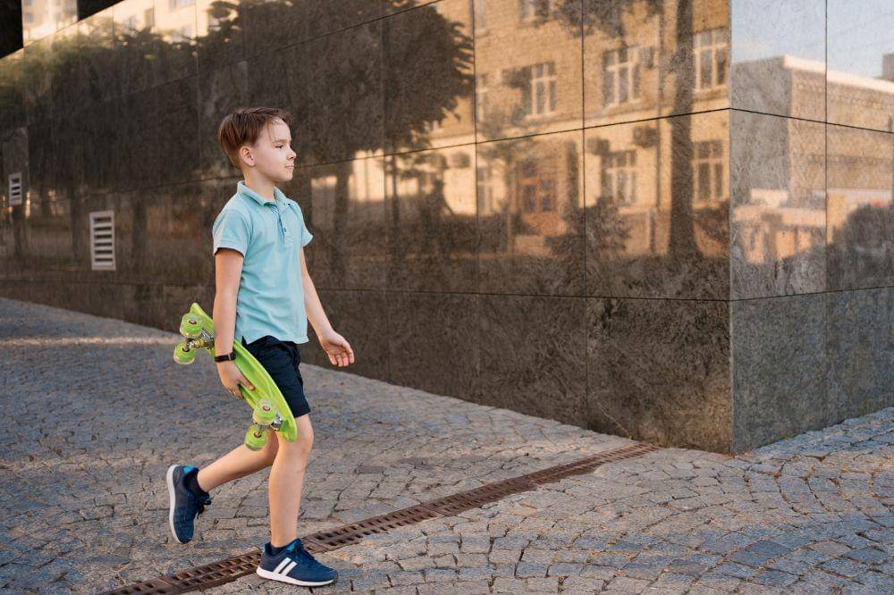 Young boy in bright clothes walking