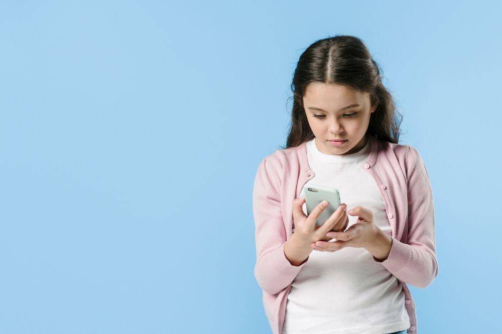 Young girl using phone in studio