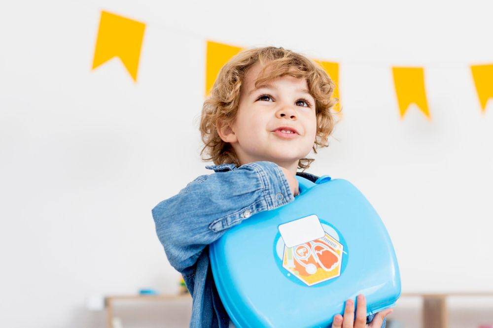 happy boy holding kit