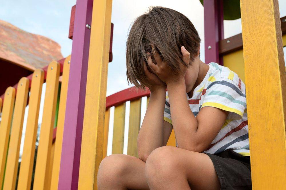 Side view  sad boy in park