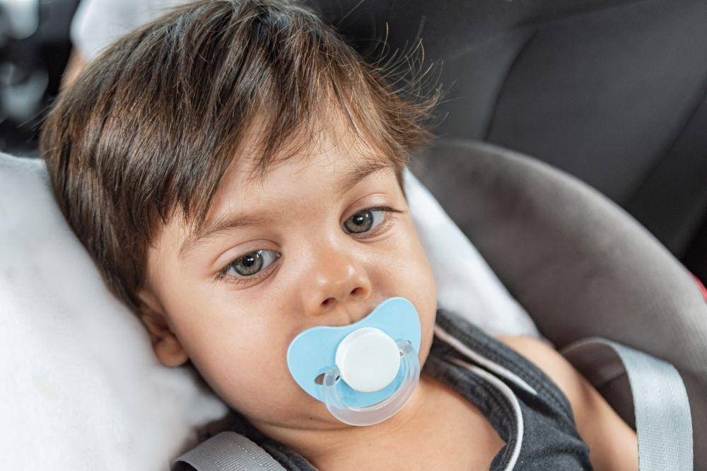 Baby boy sitting in the baby seat