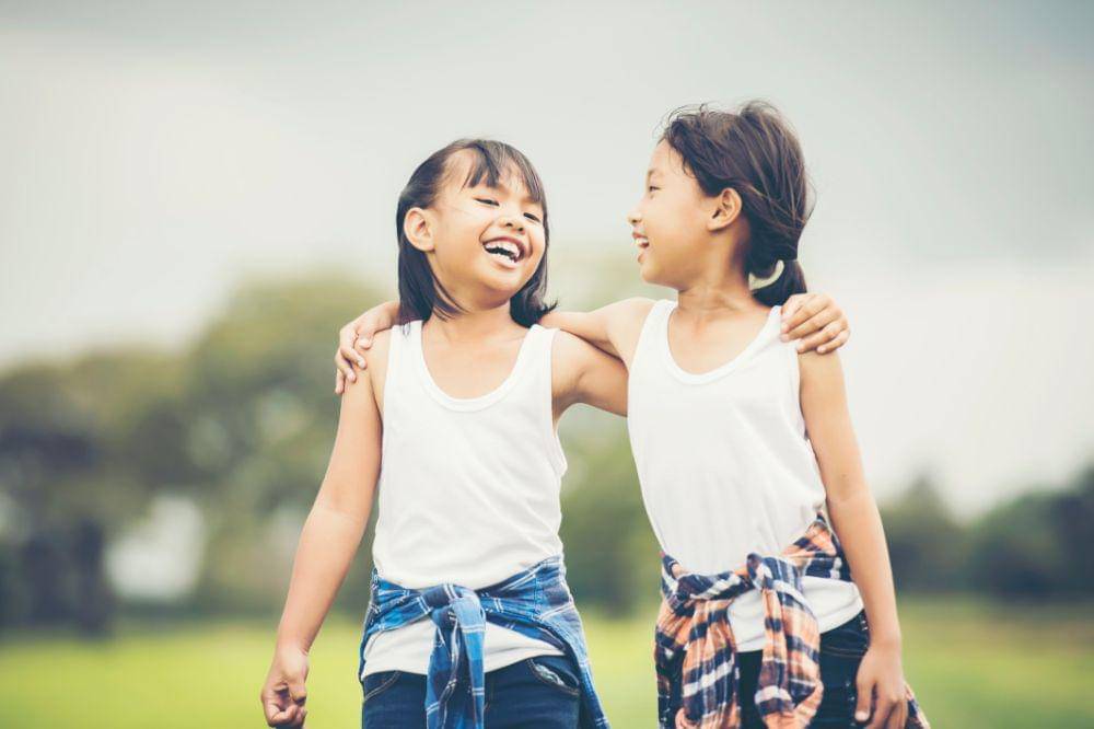 Two little girls having fun in the park