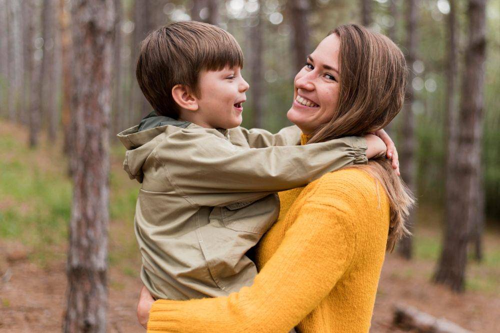 woman holding up her son
