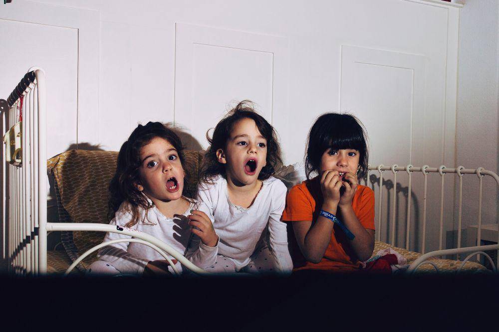 Kids in bedroom watching horror film